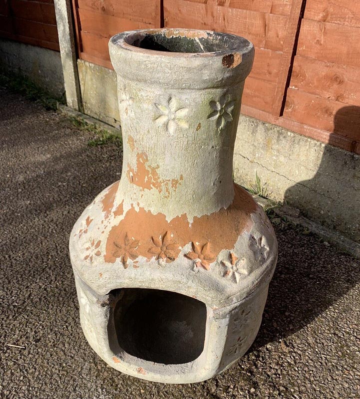 clay chiminea with damage after being left outside